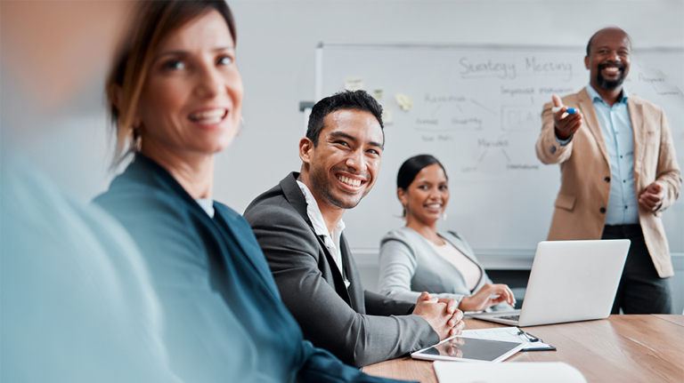 The floor is yours. Cropped shot of a handsome young businessman sitting at the boardroom table during a meeting with his colleagues.